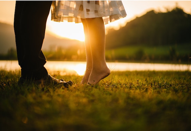 close up photo of a couples feet as they stand close together