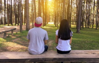 couple on bench in woods