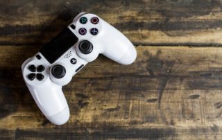 picture of a video game controller sitting on a wood table top