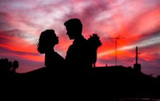 silhouette of a couple against a sunset sky