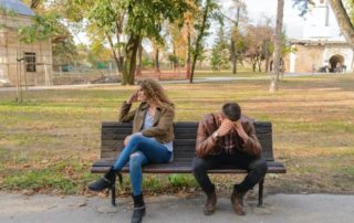 couple sitting on bench who are upset with one another