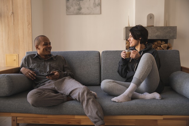 couple sitting on couch talking to each other