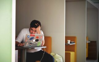 Man in White Shirt Using Macbook Pro