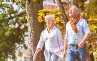 seniors-walking-woods-fall