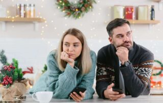 thinking couple wearing sweaters during christmas