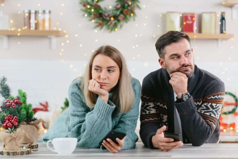 thinking couple wearing sweaters during christmas