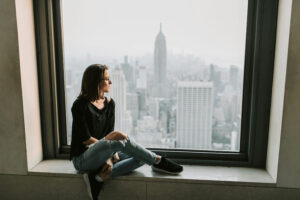 a woman overlooking NYC