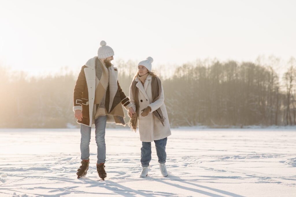 a-couple-holding-hands-while-ice-skating
