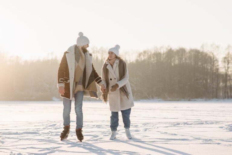 a-couple-holding-hands-while-ice-skating