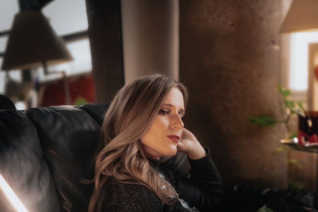 contemplative-woman-relaxing-indoors-by-window