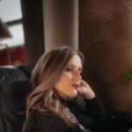 contemplative-woman-relaxing-indoors-by-window