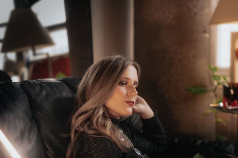 contemplative-woman-relaxing-indoors-by-window